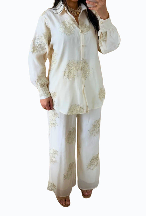 Elegant blouse and trouser set with shiny details