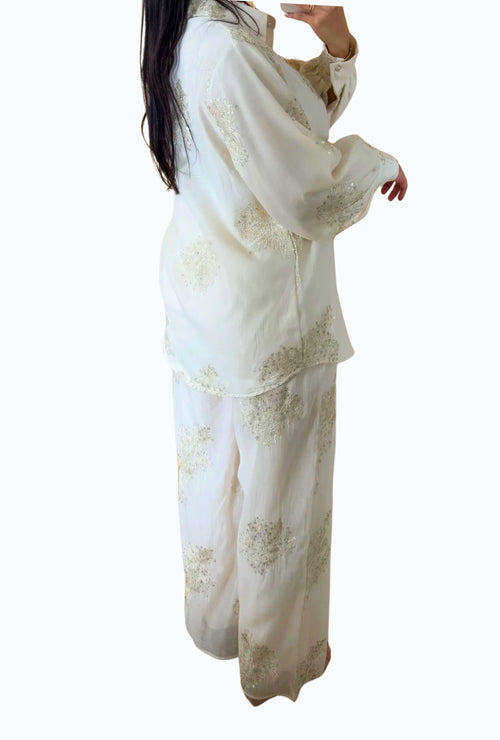 Elegant blouse and trouser set with shiny details